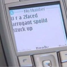 an old cell phone with a message written on the screen that says, u r a znaced arrogant spoiled stuck up