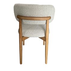 an upholstered chair with wooden legs and armrests