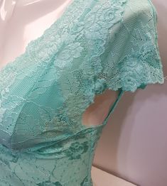 "Hand sewn capped sleeve lace crop top in light turquoise (Aruba Blue) color with floral pattern lace. 1.Perfect for any occasion. 2. Available in 4 sizes: XS, S, M, and L. 3. It has three rows of hook-eye closure at the back (see pic). 4. Made from stretch lace which helps you adjust to your body size. 5. High-quality lace material. 6. Light in weight and comfortable. 7. Has cotton lining in the inner bust area to prevent transparency. 8. Free USPS First Class shipping within the USA. Shipping V-neck Lace Crop Top With Lace Trim, Summer Lace Patchwork Short Sleeve Top, Fitted Cropped Lace Top With Scalloped Lace, Fitted Cropped Lace Top With Scalloped Edges, Stretch Lace Top With Short Sleeves, Sleeveless Lace Top With Lace Closure For Summer, Stretch Lace Patchwork Short Sleeve Tops, Fitted Lace Crop Top With Lace Closure, Delicate Lace Fitted Crop Top