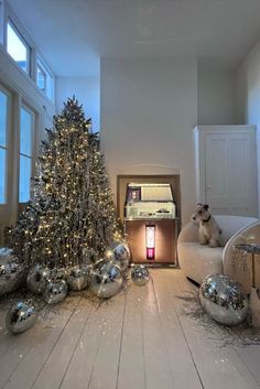 a living room filled with furniture and a christmas tree