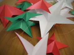 several red and green origami stars on a table