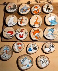 a wooden table topped with lots of buttons covered in cartoon animals and snowflakes