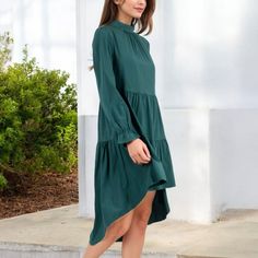 Add a touch of elegance to your wardrobe with the Anna-Kaci Women's High Neck Tiered Swing Dress. This beautiful dress features a high neckline and a tiered design that creates a flowing silhouette, perfect for any occasion. The long sleeves add a modest yet stylish element, while the swing cut ensures a comfortable and flattering fit. Whether you're heading to a special event or a casual outing, this dress is a versatile piece that pairs effortlessly with heels or flats for a chic look. Elegant Mini Dress With Layered Hem For Brunch, Elegant Brunch Dress With Layered Hem, Elegant Layered Hem Dress For Brunch, Elegant Dresses With Layered Hem For Brunch, Elegant Spring Tiered Dress With Layered Hem, Chic Tiered Dress With Tiered Skirt For Fall, Chic Tiered Dress For Fall, Elegant Tiered Dress With Layered Hem For Brunch, Chic Solid Color Tiered Skirt Dress