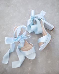 "Satin block heel sandal with wrapped satin/sheer ankle tie. Elegance and classic inspired wear for your special day. Perfect for brides, bridesmaids, prom night, date night, and definitely a highlight on every special occasions. DETAILS: HEELS: 4 inches COLORS AVAILABLE: Ivory, White and Light Blue UPPER: Synthetic upper and lining MATERIALS: Manmade outsole ORIGIN: Imported STYLE NAME: ATHENA  Not sure of which size to purchase? Shoes measurements are as follow: (Please note measurements taken Heels For Light Blue Dress, Blue Bow Wedding Shoes, Light Blue Heels With Bow, Wedding Shoes Light Blue, Light Blue Suede Heels, Light Blue Shoes Heels, Sky Blue Wedding Shoes, Elegant Bride Shoes, Light Blue Wedges