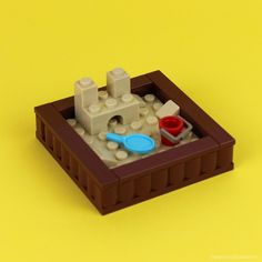 there is a lego sandbox with toys in it