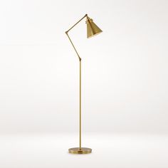 a gold floor lamp with a white background