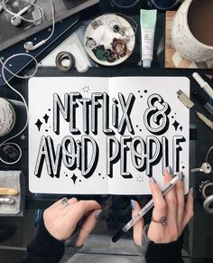 two hands holding an open book with the words netflix and avoid people written on it