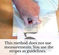 a person is cutting paper with scissors on top of some folded up papers and the words, this method does not use measurements you use the strips as guidelines