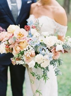 the bride and groom are holding their bouquets