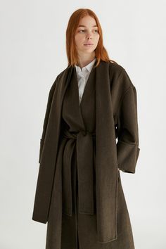 Information The Rhodes Coat is the unisex outerwear piece that you have been looking for. It's a full-length coat featuring a back pleat detail, wide-cuffed sleeves, a waist belt and an included scarf that detaches at the back button. This elevated piece is a must for your closet staples collection. Details 50% Wool, 50% Polyester Oversized Fit Waist Belt Detachable Scarf Phoebe is 5'7" and wearing a size SMeasurements: 32" Bust, 24" WaistStyle #TM1858 Full Length Coat, Archive Fashion, Wrap Coat, Closet Staples, Rhodes, Cuff Sleeves, Black Coat, Waist Belt, Oversized Fits