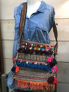 Crafted from an antique donkey saddle bag, this one-of-a-kind crossbody bag features beading, tassels, an intricate multicolor kilim pattern, and a recycled hand-woven belt for a strap. Woven into this bag is a vibrant tale of travels throughout India; The patches, tears, and imperfections found on this textile are simply a part of its history. This bag is durable, and is perfect for use as your everyday purse, market bag, or book bag.  Body Width: 13 in Body Height: 12 in Strap Height: 16 in Kilim Pattern, Everyday Purse, Woven Belt, Book Bag, Saddle Bag, Market Bag, Vintage Kilim, Saddle Bags, Cross Body Handbags