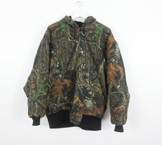 Vintage real tree camo parka lined jacket Made by wolf mountain huntingwear Size Large listed Across chest: 27 inches Length: 28 inches Sleeve: 19 inches Cotton shell, good condition! cai08 Camouflage Outerwear For Outdoor Work In Fall, Camouflage Winter Outerwear For Outdoor Work, Fall Camouflage Outerwear For Hiking, Camouflage Utility Jacket For Winter Outdoors, Camouflage Utility Jacket For Hunting In Fall, Camouflage Utility Jacket For Fall Hunting, Fall Camouflage Utility Jacket For Hunting, Real Tree Camo, Hoodie Jacket Men