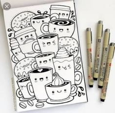 two markers and three pens are next to a drawing book with coffee mugs on it