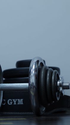 a pair of dumbbells sitting on top of a gym mat