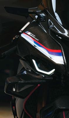 the front end of a black motorcycle with red, white and blue stripes