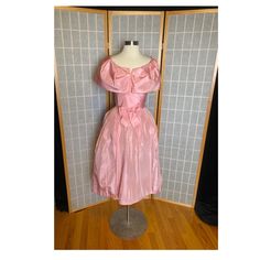 "1950's pink tea length puffy party dress with unique shoulders and waist bow. Has a large stain on the skirt, shown in photo. I haven't tried to wash out, being sold as is Lorrie Deb Size Xs 35/36\" bust 24\" waist free hips 12.5\" shoulder to hem 27\" waist to hem" Vintage Pink Ball Gown Dress, Vintage Pink Dress With Fitted Bodice For Party, Pink Vintage Dress With Fitted Bodice For Party, 1950s Style Pink Tea-length Dress, Vintage Pink Wedding Dress With Fitted Bodice, Vintage Wedding Dress With Fitted Bodice In Pink, Pink Vintage Wedding Dress With Fitted Bodice, 1950s Style Pink Party Dress, Vintage Pink Dress For Prom Season