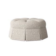 a round ottoman with pleated fabric on the top and bottom, sitting in front of a white background