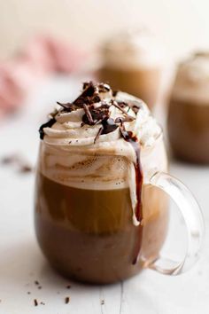 two cups filled with hot chocolate and whipped cream