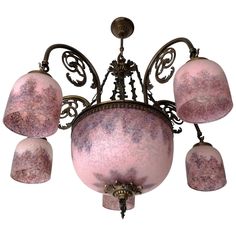 a pink chandelier with five lights hanging from it's center point,