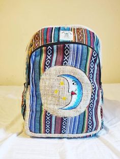 New Mens Womens Easy Carry  Himalayan Hemp Hippy Boho Vegan Stylish Multicolor Blue Smile Moon Embroid Backpack Rucksack Summer BagThis nice and colorful HEMP BACKPACK gives comfort and stylish boho look on everyday activities either in your holidays or short breaks or even better in festival.Hemp Backpack Description: - handmade- high-quality durable natural hemp textile - natural dye- lined with organic cotton- small zipped pockets in the front -two small side pockets- spacious with seprate la Bohemian Handmade Travel Backpack, Hippie Backpack Hippie Shop, Bohemian Handmade Standard Backpack, Himalayan Hemp Backpack, Blue Smile, Hemp Backpack, Hemp Bag, Festival Bag, Summer Bag