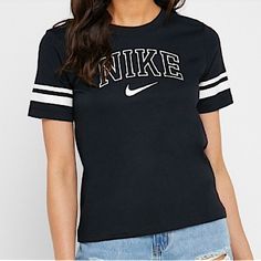 Brand: Nike. Size: Medium. Color(S): Black And White. Varsity Women’s Short Sleeve T-Shirt. New With Tags. Non Smoking/ No Pet Home. Trendy Black Tops For College, Nike Crew Neck Tops For College, Black Tops For College In Spring, Black Spring Tops For College, Nike Black T-shirt For Spring, Athleisure Text Print T-shirt, Black Athleisure Tops For College, Nike Crew Neck Top With Letter Print, Nike Graphic Print Tops For College