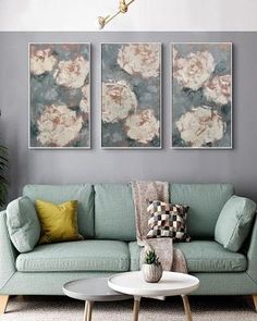 a living room with two paintings on the wall