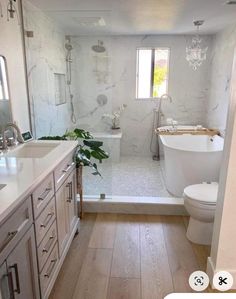 a bathroom with a tub, toilet and sink in it's center piece is shown