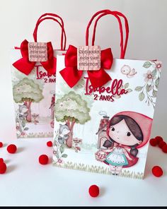 two small bags with red bows on them