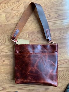 "Single pocket shoulder/crossbody tote made of 2-3 oz. Moore & Giles Leather in Walnut Brompton. Features d-rings that can accommodate shoulder or crossbody wear, finished with copper hardware.  Tote has interior magnetic closure on top. Pattern and style design by me, hand crafted in my shop. Features handmade 10\" drop shoulder strap that is removable, or an embroidered crossbody strap. 10\" wide by 9\" tall by 2\" wide. Features a lightweight leather in 2-3 oz. that is flexible and full grain Brown Crossbody Shoulder Bag With Brass Hardware, Everyday Tote Satchel With Brass Hardware, Everyday Tote Shoulder Bag With Brass Hardware, Rectangular Shoulder Bag With Brass Hardware For Everyday, Rectangular Shoulder Bag With Brass Hardware, Everyday Brown Shoulder Bag With Brass Hardware, Everyday Crossbody Saddle Bag With Waxed Finish, Everyday Satchel Shoulder Bag With Brass Hardware, Cognac Bag With Brass Hardware For Everyday Use