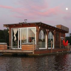 a houseboat floating on top of a body of water