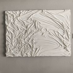 a piece of art that looks like it is made out of white paint and paper