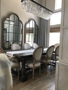 a dining room table with chairs and a chandelier