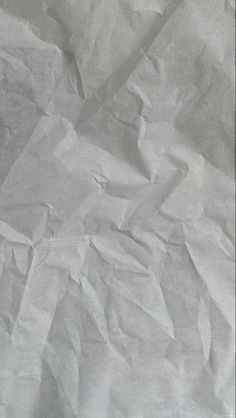 a black and white photo of crumpled paper