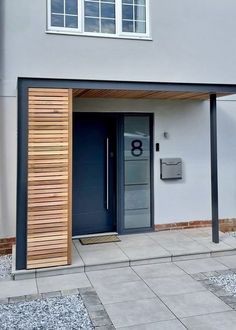 an entrance to a modern building with wooden slats on the door and side walls