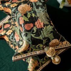 two decorative pillows on top of each other in front of a green carpeted floor