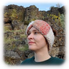 a woman wearing a knitted headband in front of some rocks