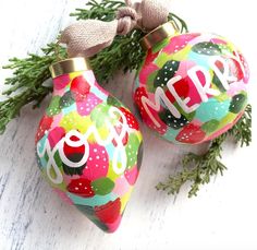 two christmas ornaments with the word noel painted on them