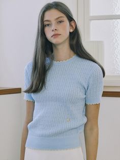 This product is a finely knit, cable-stitched top that combines the classic charm of a sweater with the ease of a t-shirt. It features a delicate contrast trim along the edges, adding a subtle pop of color to the otherwise understated design. The piece is finished with a ribbed hem and cuffs, which contribute to a snug and comfortable fit. - This top's crew neck design offers a timeless look that pairs well with various jewelry and necklines.- The cable knit pattern is meticulously crafted, adding texture and visual interest to the garment.- Its short sleeves make it suitable for warmer days or can be layered during cooler seasons.- A pair of small, decorative buttons at the hem introduces an element of sophistication to the overall design. Shannara Chronicles, Cable Knit Pattern, Volleyball Team, Decorative Buttons, Knit Pattern, Pretty Selfies, Contrast Trim, Knit Patterns, Neck Designs