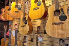 guitars are hanging up on the wall