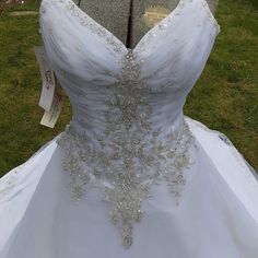 a wedding dress is displayed on display in the grass