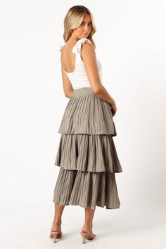 DETAILS
 Dance through your day in style with our Rylan Maxi Skirt in Dusty Sage! This trendy piece, cascading to a maxi length, features a comfy elasticised waistband and a drop tiered ruffle design that adds a playful twist to your look. Crafted from a light, plisse material, it's the perfect pick to make a fashion-forward statement.
 
 maxi length
 elasticised waist band
 drop tiered ruffle design
 plisse material
 lined
 
 material - 100% polyester
 
 
 
 
 
 
 
 
 
 SIZING
 
 model is 5' 5" and wears a Size S
 model stats: bust - 31.5", waist - 25.5", hips - 37"
 
 
 
 
 
 
 
 
 
 
 
 
 
 
 
 GARMENT CARE
 
 cold hand wash separately Chic Flowy Tiered Skirt, Chic Pleated Tiered Bottoms, Chic Tiered Pleated Bottoms, Casual Tiered Maxi Skirt For Brunch, Flowy Tiered Maxi Skirt For Day Out, Flowy Tie Waist Tiered Skirt, Flowy Tiered Skirt With Tie Waist, Flowy Tiered Bottoms For Day Out, Chic Tie Waist Tiered Skirt Bottoms