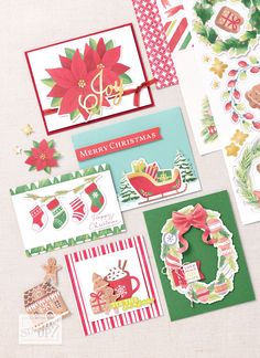 some christmas cards are laying next to each other on a white surface with red and green trimmings