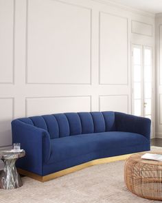 a living room with white walls and blue couches