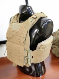 the back of a body armor sitting on top of a wooden table