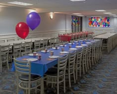 tables and chairs are set up with balloons in the air for a party or celebration