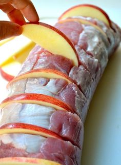 sliced up meat and apple slices on a cutting board