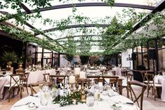 an indoor dining area with tables and chairs set up for a formal dinner or party