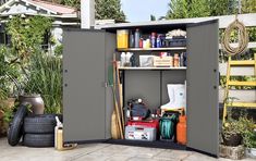 an outdoor storage shed with tools and other items in the open area next to it