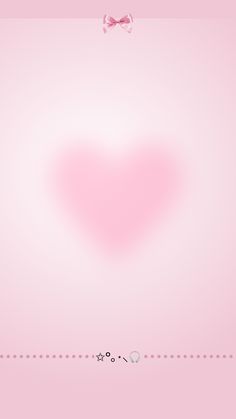 a pink background with a heart shaped object in the middle and a bow on top