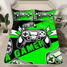 a bed with two video game controllers on it and the words gamer written in green